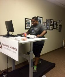 ASM employee working at a treadmill desk.