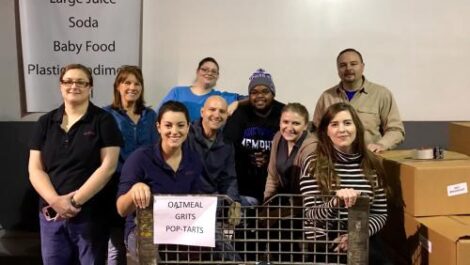 ASM employees smiling for a photo while volunteering.