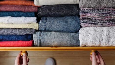 Organized dresser drawer of shirts and pants.