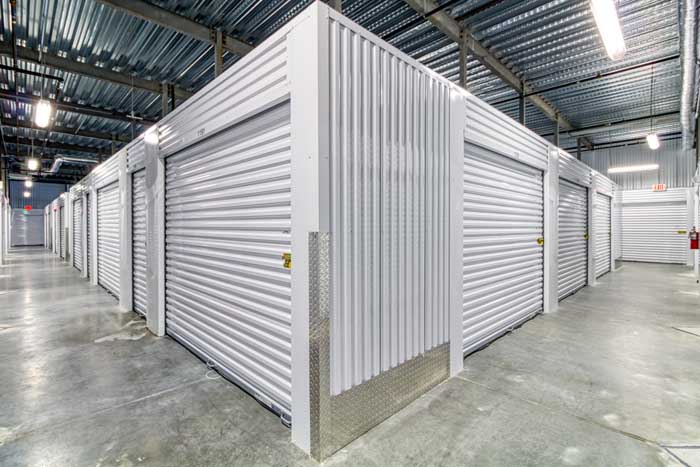 Interior storage units with white roll-up doors.