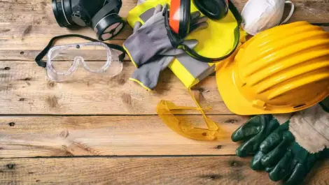 A wooden surface with construction tools laying on it.