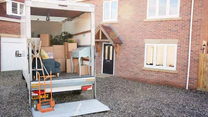 moving truck packed with items in front of an apartment building or home