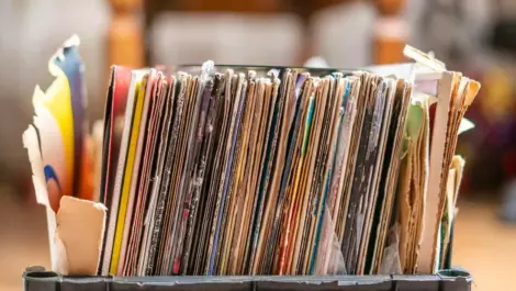 a stack of documents sits in a plastic crate