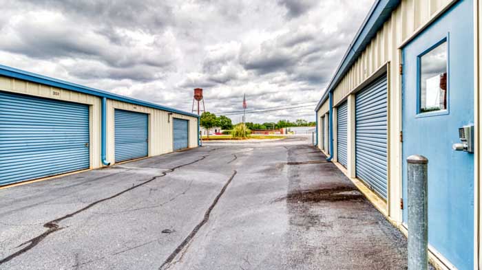 A row of outdoor, drive-up access storage units.