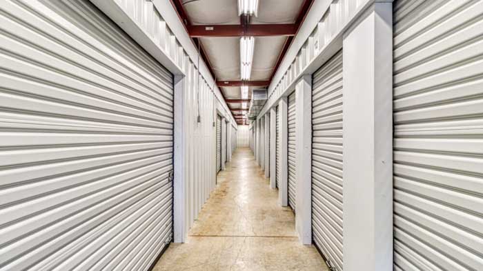 Interior storage units with white roll-up doors.