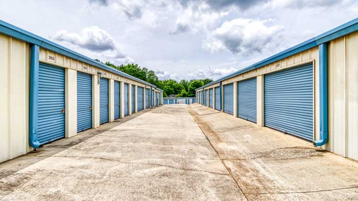 A row of outdoor, drive-up access storage units.