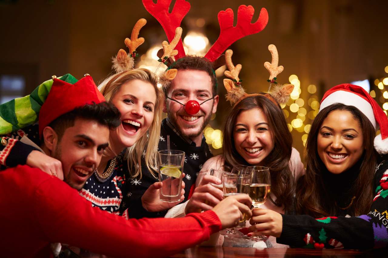 A group of friends toasting at a holiday party