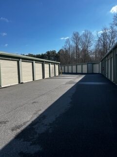 An aisle of outdoor drive-up access storage units.