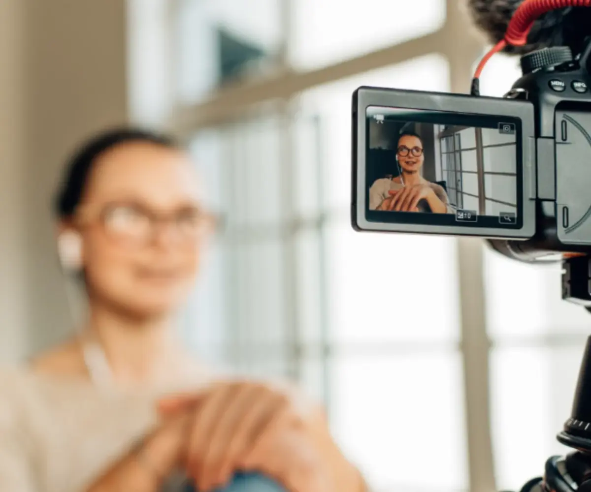 An Absolute Management employee being recorded with a video camera.