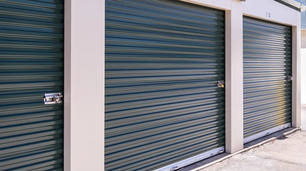 Outdoor, drive-up access storage units with roll-up doors.