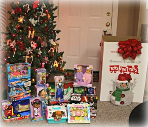 Toys for Tots toys around a Christmas tree.