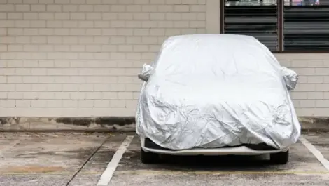 A car wrapped up in a vehicle storage parking lot.