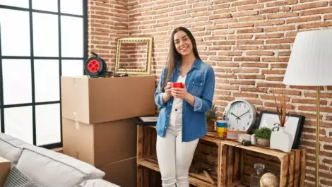 A woman standing in a studio apartment