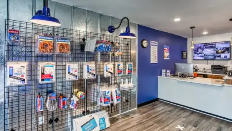 Interior of storage facility office with customer service desk and moving and packing supplies.