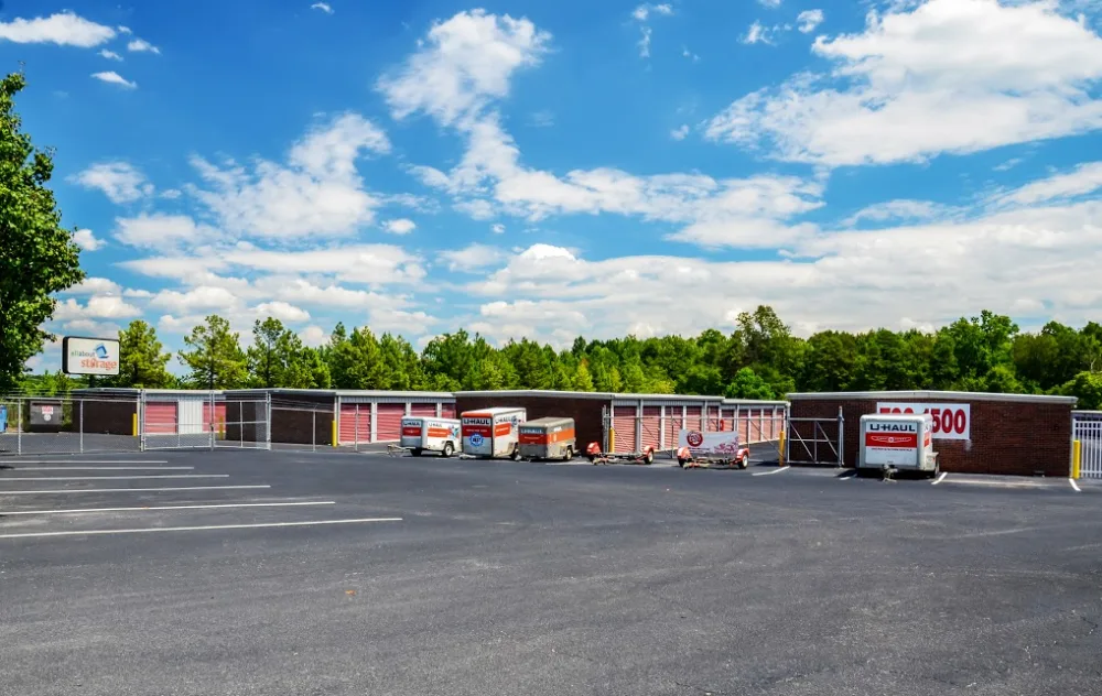 U Haul trailer in front of gated fence.