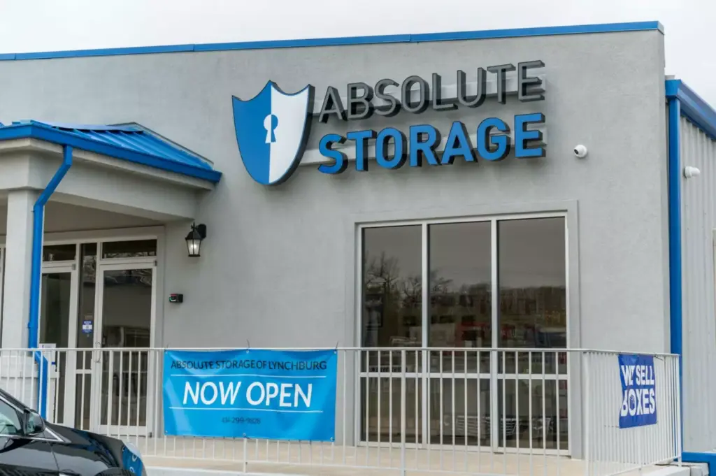 Absolute Storage "Now Open" sign.
