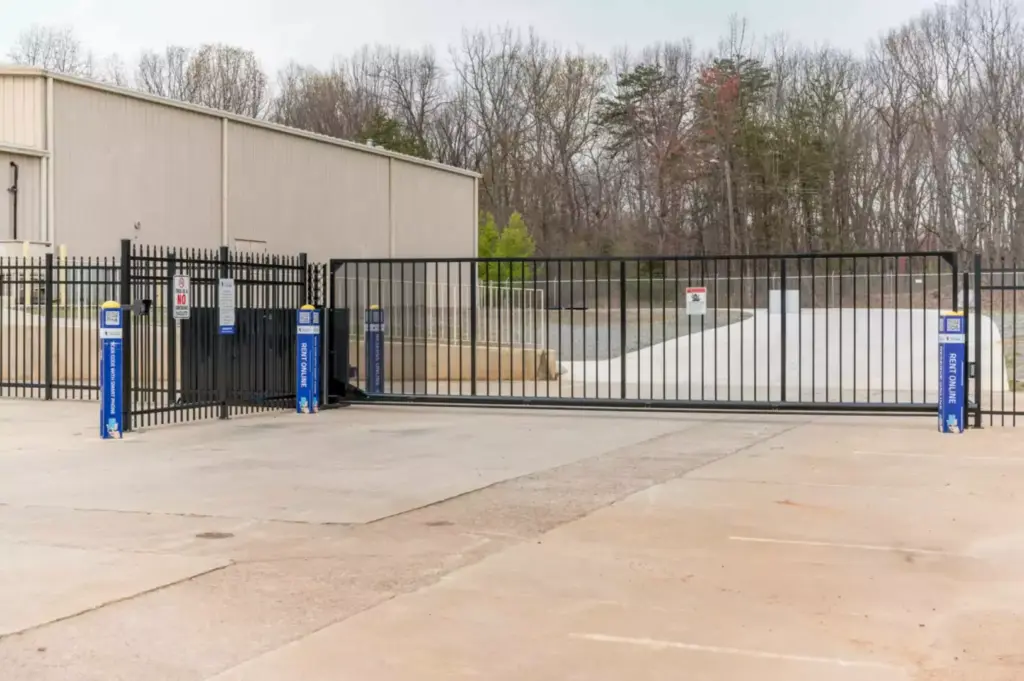 Image of a black gated fence with code box to enter.