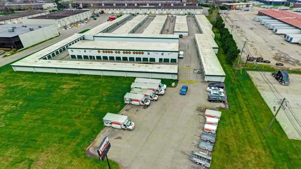 Aerial view of storage units and vehicle parking.