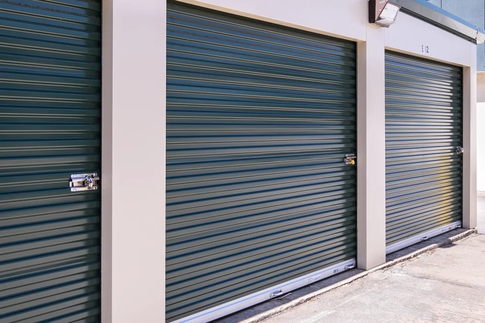 Outdoor, drive-up access storage units with roll-up doors.