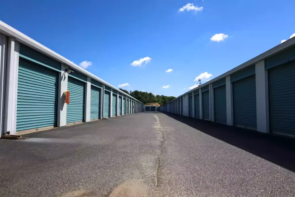 Ally view of storage units with teal doors.