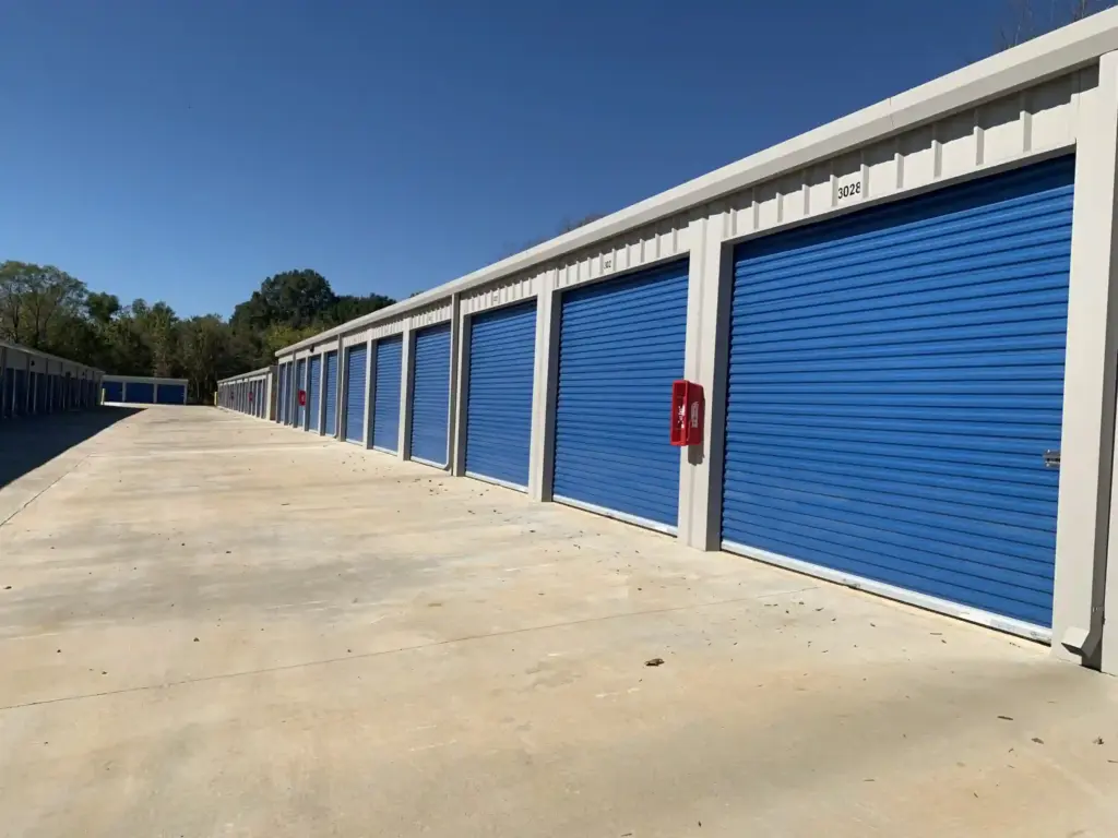 Row of large blue outdoor storage lockers.