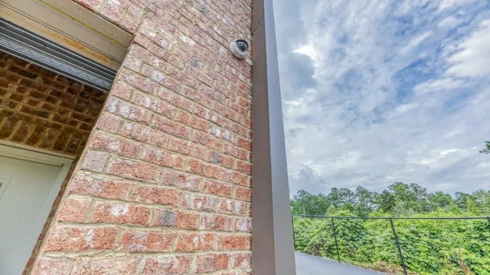 Security camera on storage unit building.