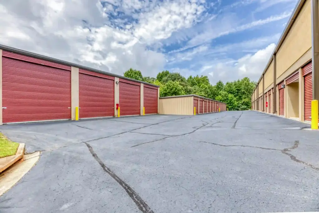 Outdoor storage units with red doors.