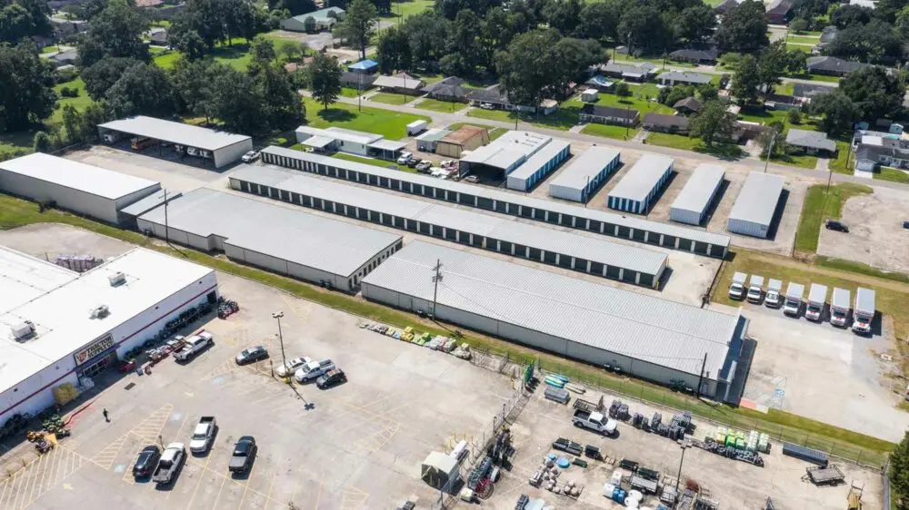 Aerial view of storage units and vehicle parking.