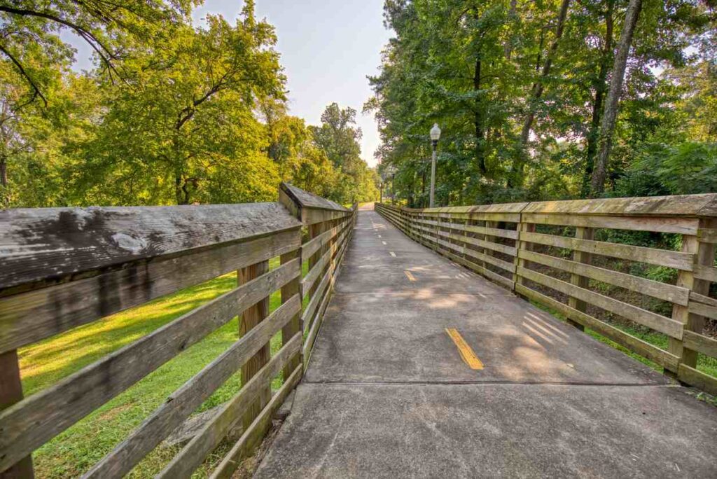 A tree-shaded bridge at the Tuscaloosa Riverwalk.
