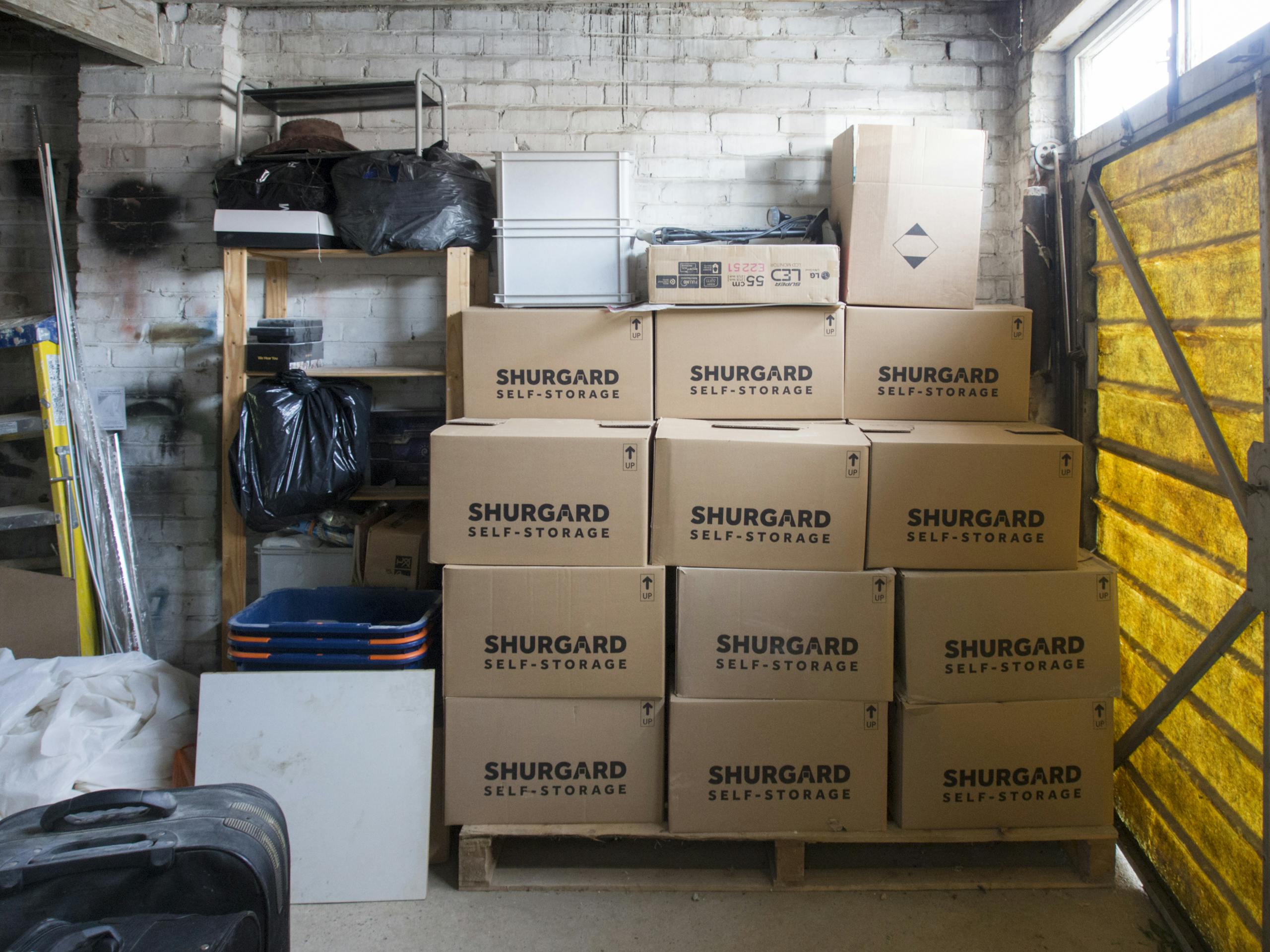 A stack of storage boxes in a well-organized warehouse interior.