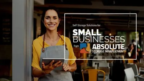 A small business owner standing at the entrance of her storefront.