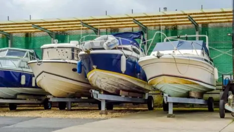 A row of boats under covered storage.