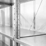 Empty stainless steel shelving in a storage unit.