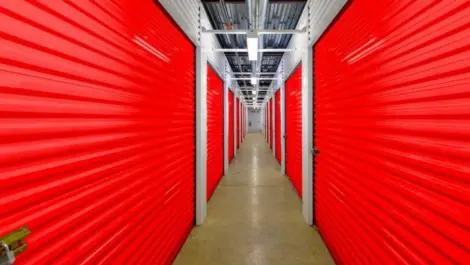 A row of indoor self storage units colored red.